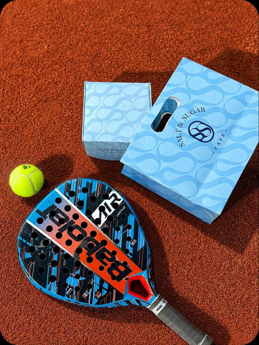Salt and Sugar padel gear and packaging on court